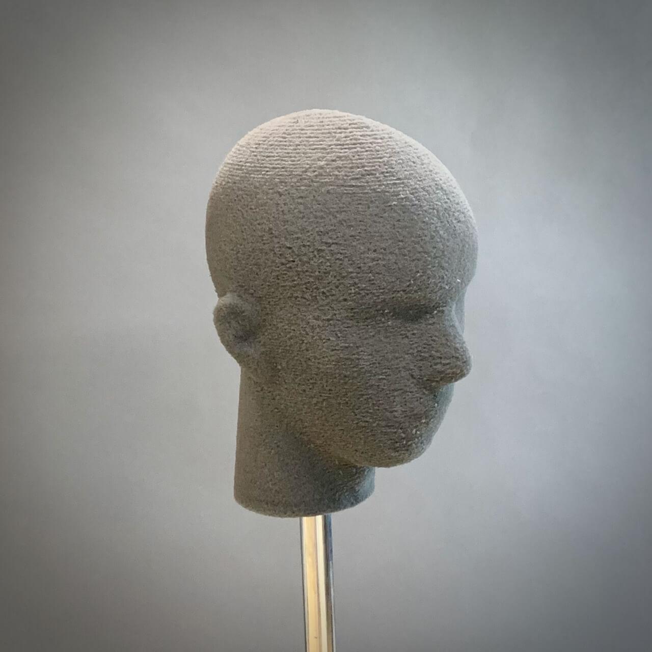 A custom head fit form on a stand pole.